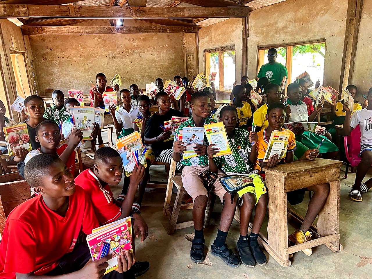 Students and a Stone of Help Youth Foundation volunteer during the classroom distribution
