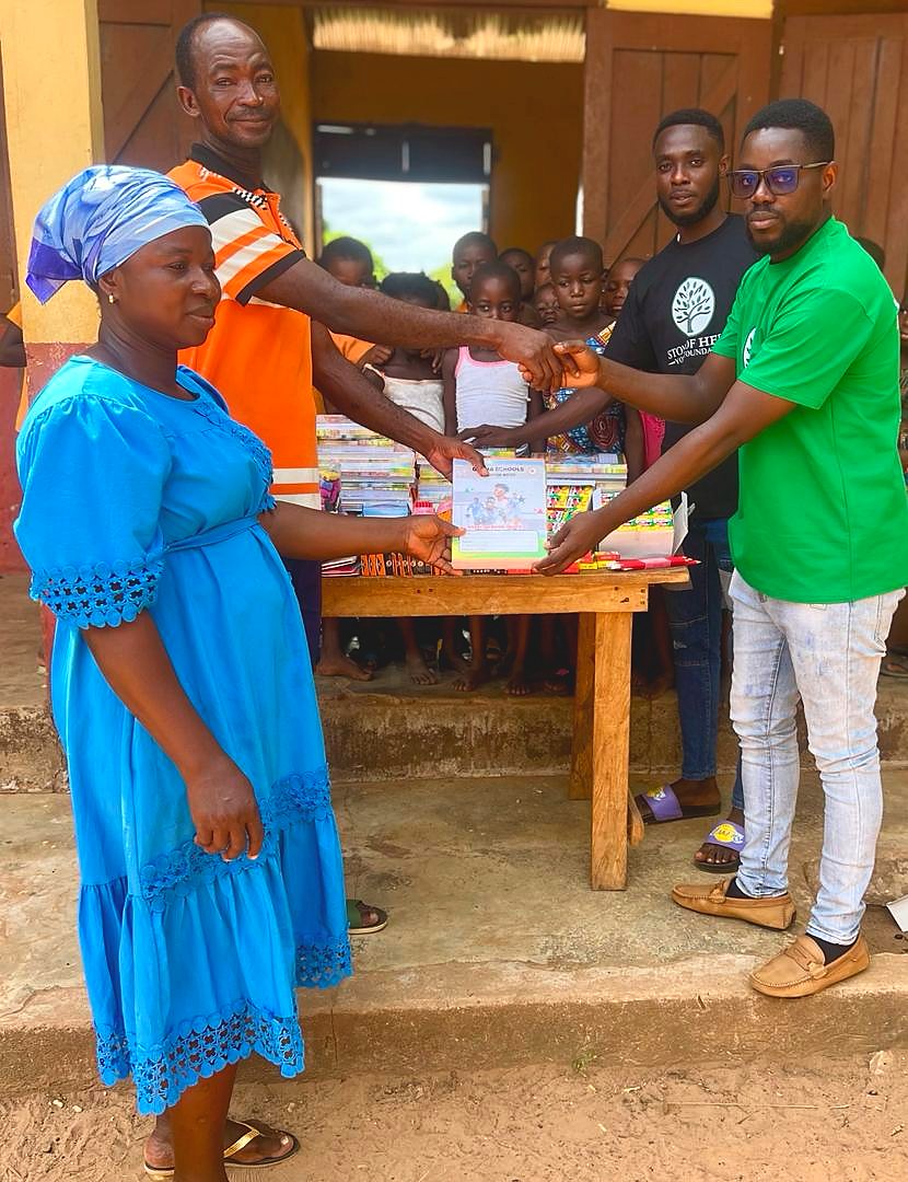 Garden of Knowledge and Stone of Help partners presenting exercise books to school leaders