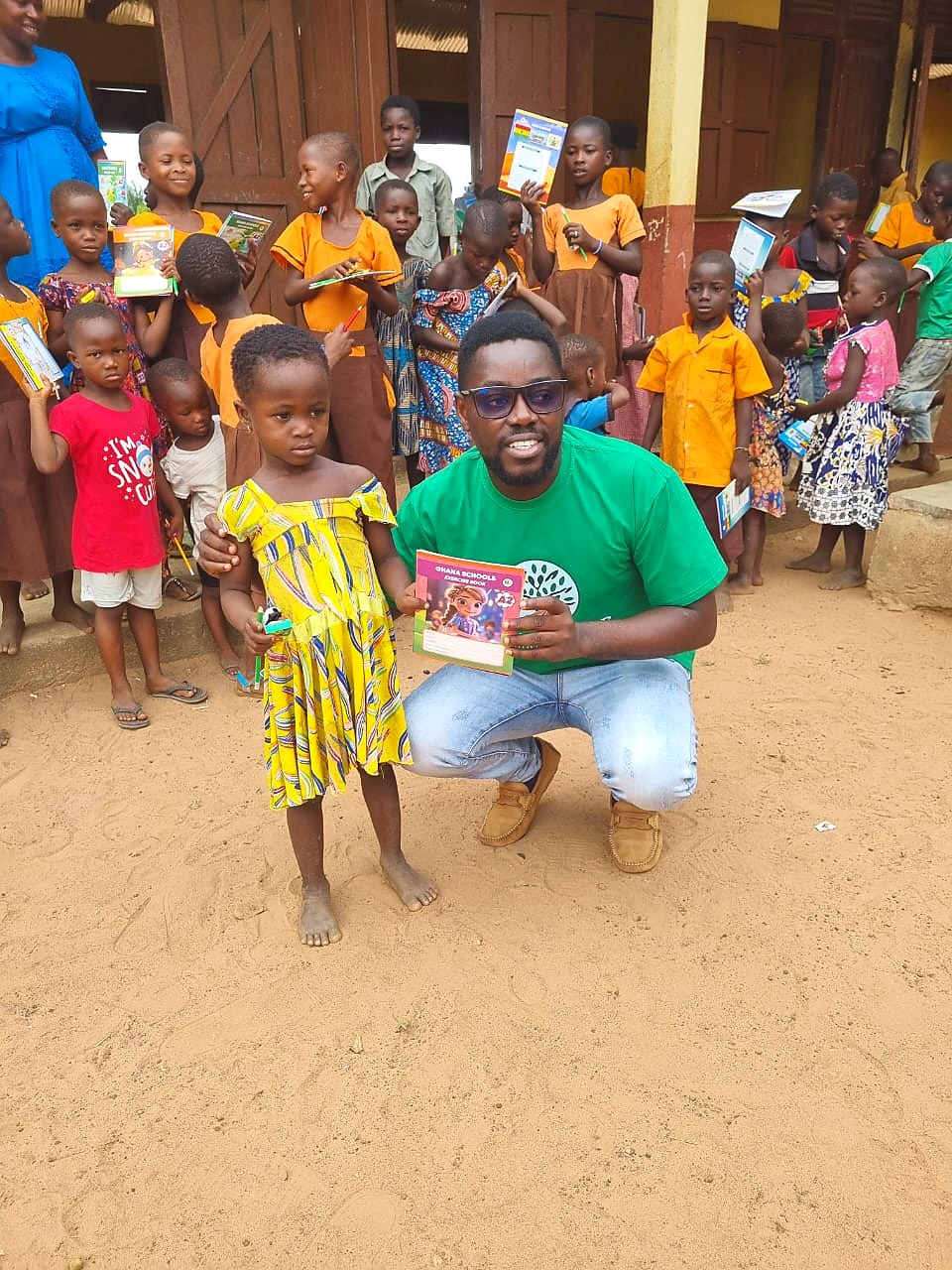 A young student standing with an exercise book beside a Garden of Knowledge partner
