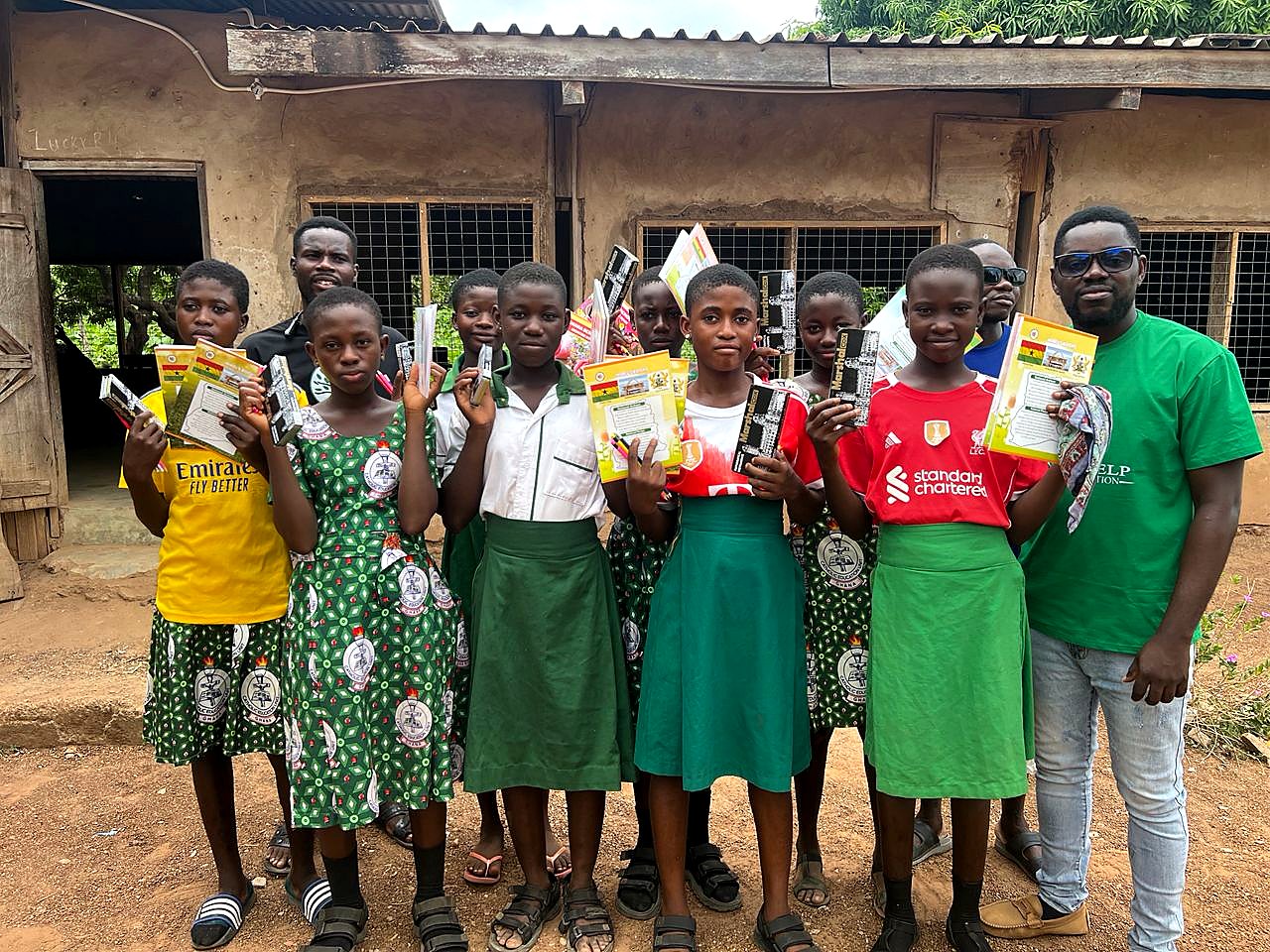 Students and partners standing together with donated school materials